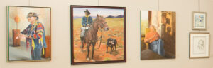 Several art pieces hanging on a wall