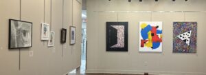 Several art pieces hanging on a wall